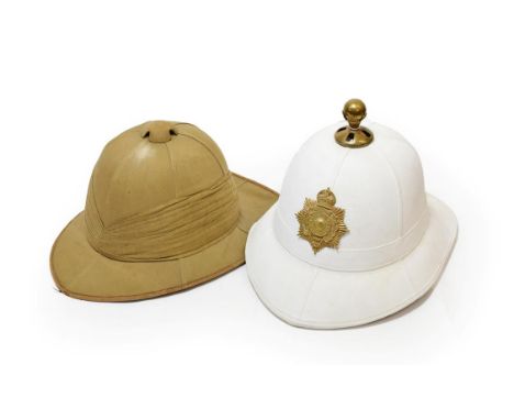 An Early 20th Century Wolesley Pattern Tropical Helmet, of cork covered in tan cloth, with six panel top and nine pleat pugga