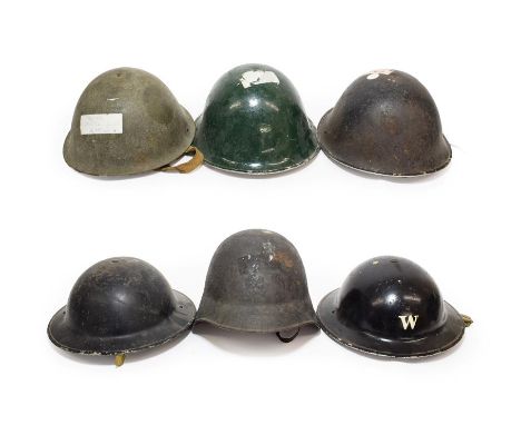 A Collection of British Military Headgear, comprising two Second World War black painted Brodie helmets, three British turtle