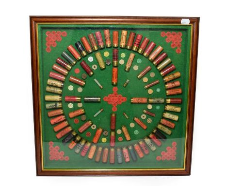 SHOTGUN CERTIFICATE REQUIRED FOR THIS LOT A Vintage Cartridge Display, set as a roundel with various components on a green ba