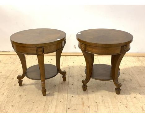 A pair of French Empire style walnut lamp tables, the circualr tops raised on shaped and square tapered supports united by an