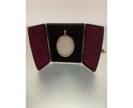 An Edwardian oval yellow metal miniature portrait frame complete with original burgundy leather fitted case with velvet lined