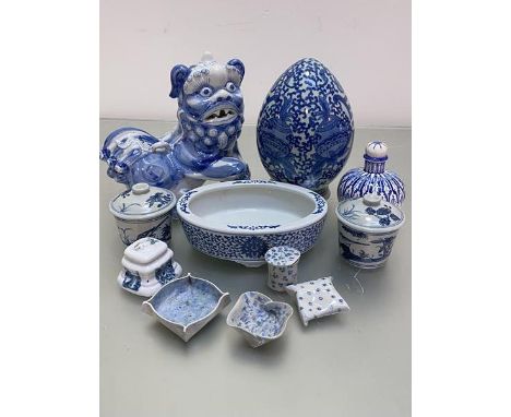 A group of Oriental and Continental pottery ceramics including a Chinese blue and white temple dog, an egg ornament on stand,