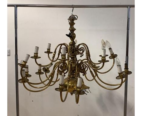 A Large gilt brass Dutch style chandelier, with ceiling rose, chain, and eighteen scrolled branches with faux candle bulb hol