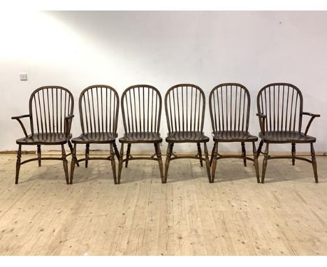 A set of six (4+2) oak Windsor chairs, with hoop and spindle back rest over saddle seats, raised on ring turned supports with