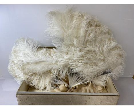 An early 20thc ladies ostrich feather and mother of pearl fan, marked Carrie, (41cm x 64cm) a/f, in original box