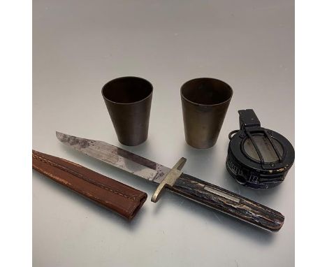 A stag's horn handled knife and leather scabbard, two trench art tapered cylinder brass beakers, (h 6cm x w 5cm) and a WWII T