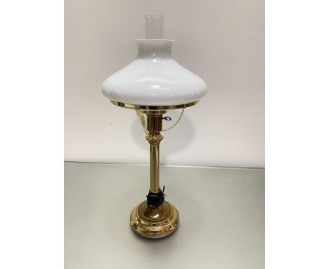 A brass oil lamp style lamp with opaque glass shade complete with glass funnel on circular stepped base (h 68 cm x d 17cm)