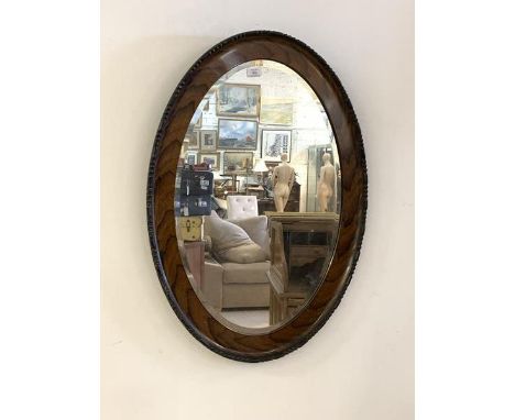 A vintage 1930s oval wall hanging mirror in moulded frame, 85cm x 62cm
