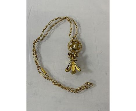 A yellow metal pendant having flower head with single cultured pearl within circular frame above a second waisted pendant wit