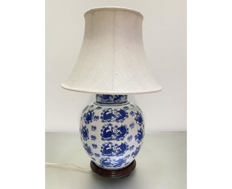A Chinese blue and white baluster ginger jar style vase lamp decorated with koi carp, with raw silk and linen mix shade (h 37