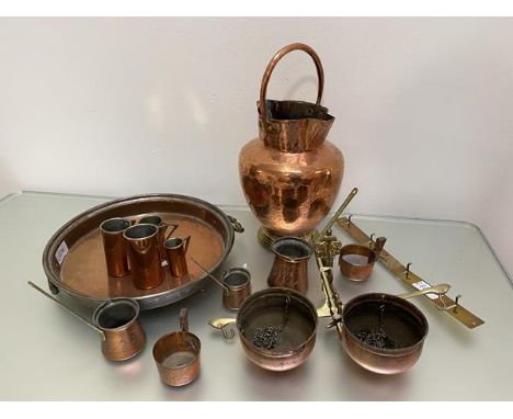 A quantity of copper and brass including a double spouted pitcher with handle, (h 41cm), a set of four graduated measuring cu