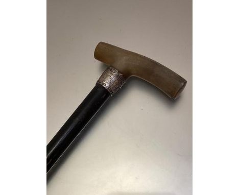 A late 19thc presentation horn handled ebony walking stick with white metal chased collar presented to Doctor Machan by Freuc