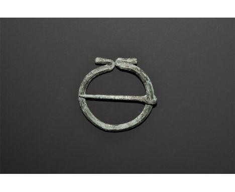 1st century AD. A lozenge-section penannular bar with reversed club terminals, tapering pin and integral loop. 12 grams, 45mm