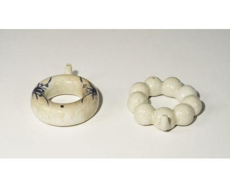 Ming Dynasty, 1368-1644 AD. A group of two annular baby-feeeders, comprising: one formed as a blue-glazed ring of nine connec