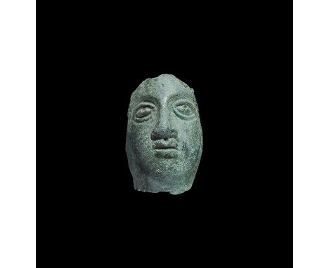 4th century AD. A cast convex female face with lentoid eyes and small pouting mouth. 20 grams, 36mm (1 1/2"). Ex Robinson col