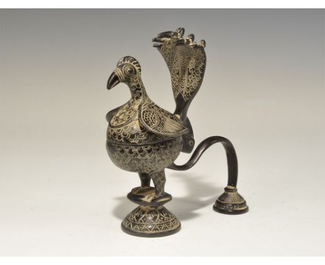 India, 19th-early 20th century AD. A cast incense burner formed as a stylised peacock on a pedestal base with scrolled strap 