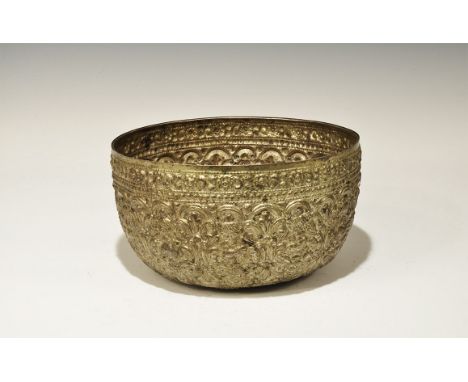 20th century AD. A hand-decorated repoussé bowl with chamfered rim, bands of floral detail, palmettes and arcade of fruit, ea