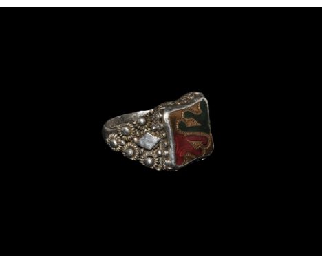 20th century AD. A D-section hoop with expanding shoulders,raised studs with collars and lozenge plaques; the bezel a raised 