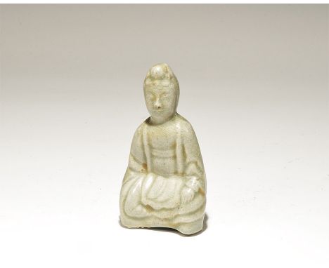 19th century AD. A hollow-moulded ceramic green-glazed figurine of Buddha in cross-legged pose, in loose robes with asterisk 