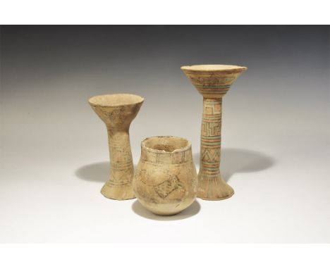 3300-1700 BC. A mixed group comprising: two tall narrow-stemmed chalices, each with flared bowl and base, polychrome geometri