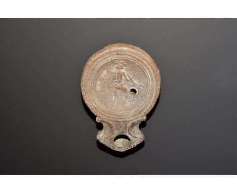 An undated archaistic oil lamp in 1st century AD style, a broad discus and broad nozzle with volute scrolls to the neck, low-