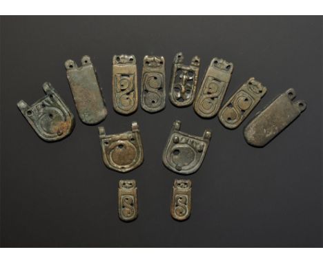 8th-9th century AD. A mixed group of Saxon period mounts comprising: two tongue-shaped panels, each with chamfered rim to the