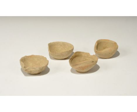 1st millennium BC. A group of four ceramic oil lamps, each with discoid base and broad bowl with pinched spout. 277 grams tot