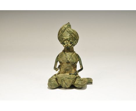 India, 19th-early 20th century AD. A figurine of bearded male with turban and dhoti, earrings and necklace pendant; playing a