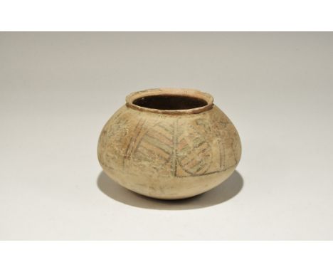 3300-1700 BC. A squat terracotta jar with chamfered rim, band of polychrome ornament to the shoulder with peepal leaf, bird a