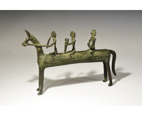 India, 19th-early 20th century AD. A cast model horse with bridle, reins and saddle blanket, three riders to the back with sw