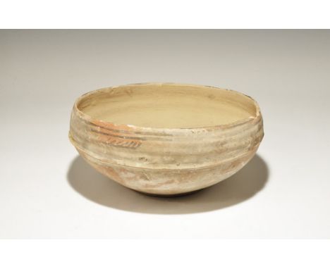 3300-1700 BC. A broad terracotta bowl of keeled profile with painted band of fronds to the shoulder. 900 grams, 23.5cm (9 1/4