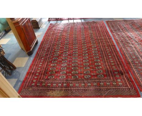 A Patterned Woollen Carpet on Red Ground, 189cm x 283cm 