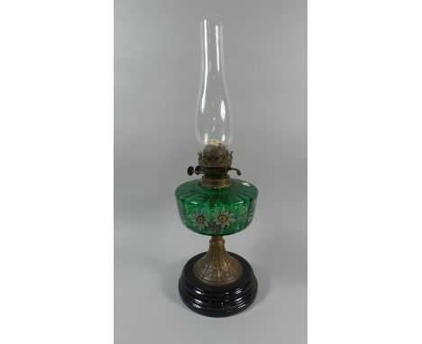 A Late Victorian Brass and Ceramic Oil Lamp with Green Glass Reservoir Decorated with Flowers 