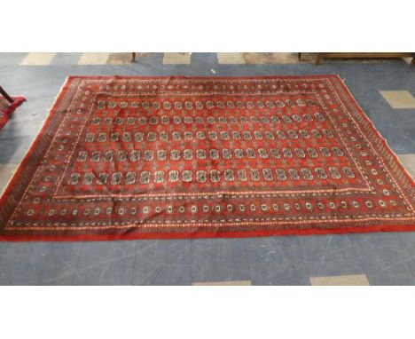 A Vintage Patterned Woollen Carpet on Red Ground, 187cm x 272cm 