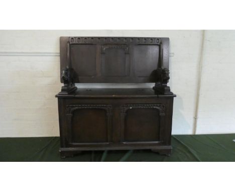 An Edwardian Oak Monks Bench with Hinged Three Panelled Back and Carved Lion Support, 95cm Wide 