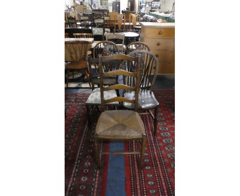 A Set of Three Elm Seated Wheel Back Chairs and Two Ladder Back Side Chairs 