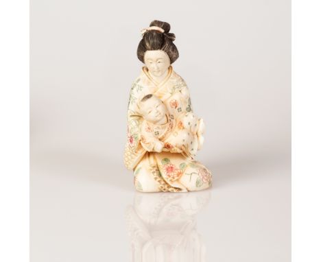 Japanese Mammoth Bone Sculpture in the figure of a Geisha Holding a Baby.  Item illustrated with colors, signed.  Height: 11 