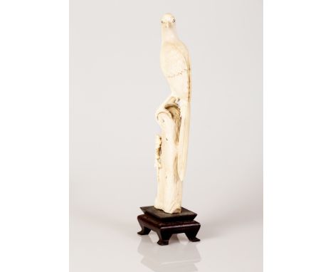 Old Chinese\Japanese Bone Sculpture in the figure of a Bird on a Tree Branch.  The item is situated on a wooden stand, extrem