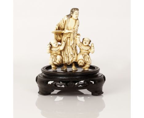 Japanese Meiji (1868-1912) Okimono Statuette depicting a scene of a long haired music player wearing traditional garments and