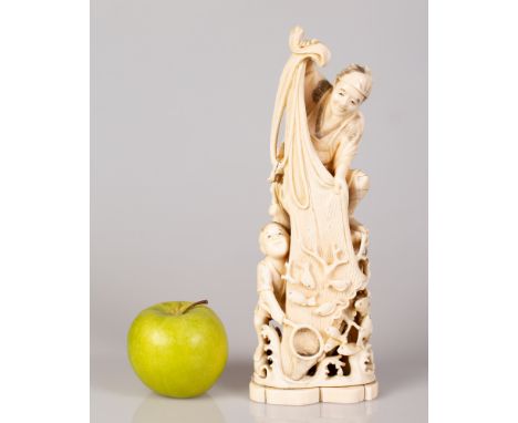 Chinese marine bone sculpture in the figure of a fisherman with his son returning from fishing and holding a net with plenty 