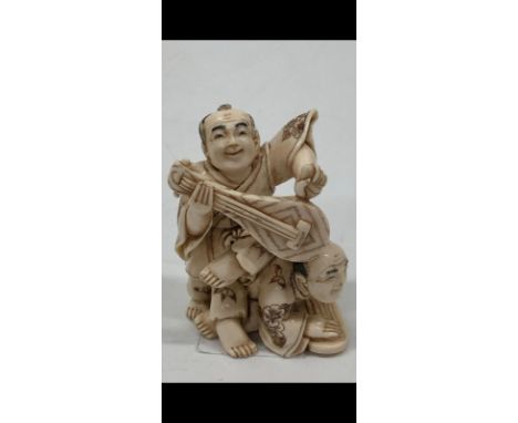 Old Bone Netsuke in the fiure of Two String Players Sitting One on Top of the Other's Back.  Item illustrated by hand and sig
