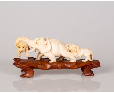 Old Japanese\Chinese Bone Statuette with a scene of Two Lions & an Elephant Fighting for Survival on a matching wooden stand.