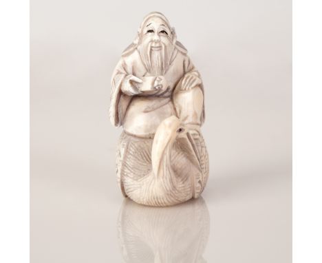 Old Japanese Bone Netsuke with a scene of a Bearded Monk Sitting on Stork.  Unique beautiful item.  Dimensions: 5X5X3 cm.