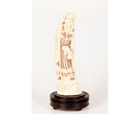 Chinese marine bone sculpture with a scene of a Chinese wiseman grabbing awand and an exotic fruit in his hands.  Beginning o
