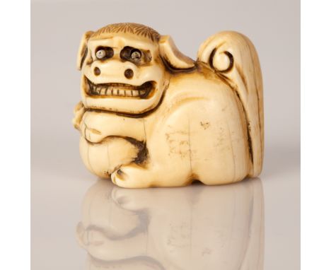 Japanese netsuke, bone in the figure of a Foo Dog with protruding eyes. Meiji period, a rare unique signed item. Dimensions: 
