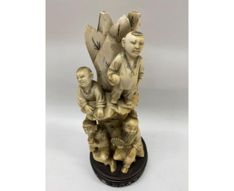 Chinese bone sculpture in a scene of a couple of immortals and children standing on the mountainside, the item is situated on