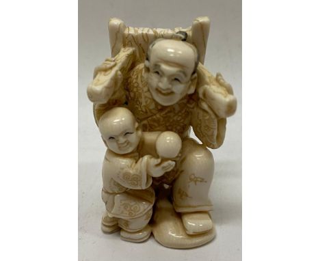 Old Bone Netsuke in the figure of a Man with a Child Carrying a Bundle of Straw on His Back. Item illustrated by hand and sig