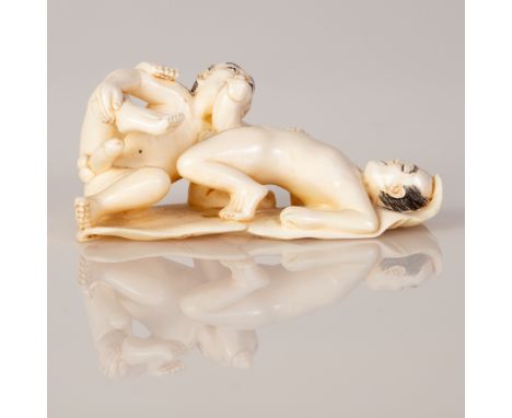 Japanese erotic Mammoth bone netsuke of a gay couple making love.  Finely crafted and signed.  Dimensions: 2/5 cm.