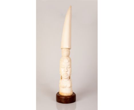 Full African Bone Tusk in the figure of a Bare-Breasted Adolescent Girl on a wooden stand.  Large impressive item.  Height in