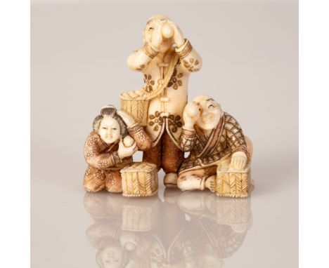 Bone netsuke with a scene of a family ball playing.  Illustrated by hand and signed.  Dimensions: 4X3X2 cm.